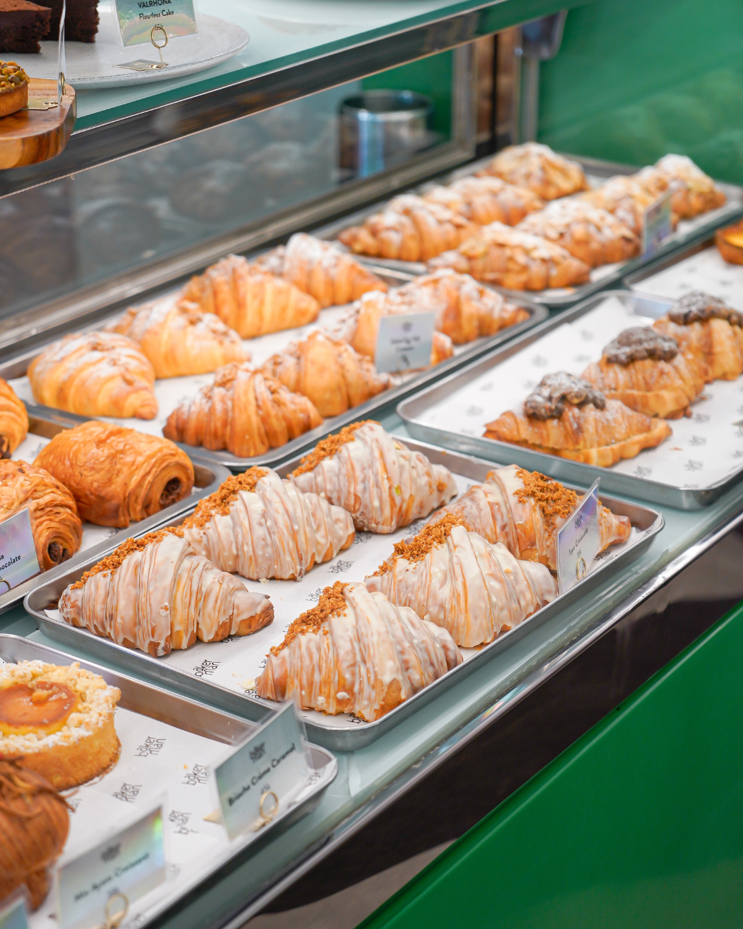 Croissants on display at a pastry shop and brunch spot in Jakarta with fresh bakes and coffee